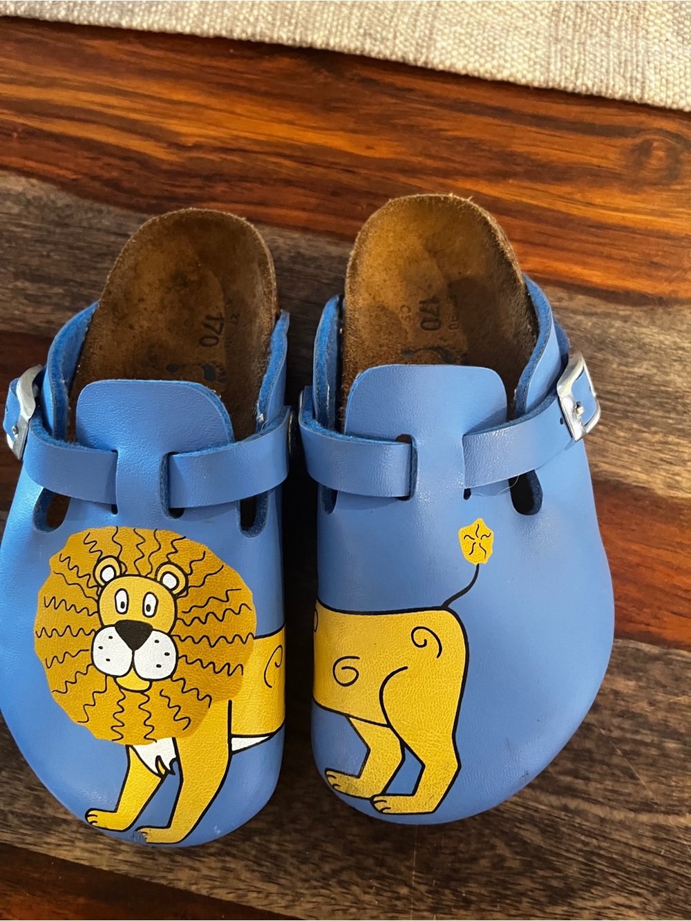 Birkenstock Kids Blue Leather Slip-On Clogs with Yellow Lion Artwork